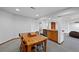 Open basement area featuring a dining table and wet bar, perfect for entertaining at 9 Red Fox Ln, Littleton, CO 80127