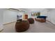 Basement Gathering room with two large beanbag chairs, TV, and large windows at 9 Red Fox Ln, Littleton, CO 80127