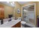 Bathroom with shower, bench seat, decorative mirror, and vanity sink at 9 Red Fox Ln, Littleton, CO 80127