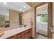 Bathroom with a vanity, a large mirror, and a shower over a bathtub at 9 Red Fox Ln, Littleton, CO 80127
