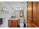 A bright, well-lit bathroom features a sink and a toilet. Laundry is accessible from the bathroom at 9 Red Fox Ln, Littleton, CO 80127