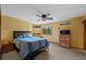 Comfortable bedroom with ceiling fan, large window, and warm yellow walls at 9 Red Fox Ln, Littleton, CO 80127
