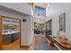 Bright foyer with high ceilings, hardwood floors, and views into the dining room and kitchen at 9 Red Fox Ln, Littleton, CO 80127