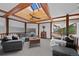A gray sectional in the living room sits beneath a skylight, bringing natural light into the living space at 9 Red Fox Ln, Littleton, CO 80127