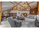 Expansive living room with vaulted ceilings, exposed beams, and natural light at 9 Red Fox Ln, Littleton, CO 80127