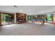 Basement living room with fireplace, pool table, and sliding glass doors at 9 Red Fox Ln, Littleton, CO 80127