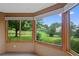 Bright interior room with large windows and a view of a beautifully landscaped lawn at 9 Red Fox Ln, Littleton, CO 80127