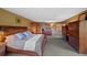 The main bedroom features wood furniture and multiple doors leading to other rooms within the house at 9 Red Fox Ln, Littleton, CO 80127