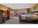 A spacious main bedroom features a sitting area with bright windows and furniture with wood accents at 9 Red Fox Ln, Littleton, CO 80127