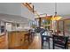 Open concept kitchen and living space with hardwood floors and modern fixtures at 9 Red Fox Ln, Littleton, CO 80127