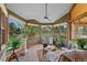 Cozy sunroom with large windows, tile flooring, and comfortable seating at 9 Red Fox Ln, Littleton, CO 80127
