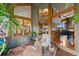 Sunroom overlooking the backyard featuring natural light and comfortable seating at 9 Red Fox Ln, Littleton, CO 80127