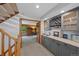 Modern wet bar with custom cabinets, wine rack, and sink at 9 Red Fox Ln, Littleton, CO 80127
