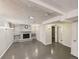 Finished basement featuring a brick fireplace, shelving, and grey wood-look flooring at 10951 Rosalie Dr, Northglenn, CO 80233