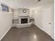 Basement with a brick fireplace, shelving, grey wood-look flooring, and good lighting at 10951 Rosalie Dr, Northglenn, CO 80233