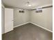 Basement bedroom with wood-look floors, two windows, and a white paneled wall at 10951 Rosalie Dr, Northglenn, CO 80233