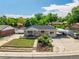 Charming single-story home with a well-maintained front yard and a convenient carport on a sunny day at 10951 Rosalie Dr, Northglenn, CO 80233