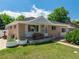 Charming brick home with well-maintained front lawn, mature landscaping, and inviting porch at 10951 Rosalie Dr, Northglenn, CO 80233