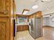 Cozy kitchen featuring wooden cabinets, stainless steel appliances, and natural light from the window at 10951 Rosalie Dr, Northglenn, CO 80233