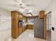 A well-lit kitchen features oak cabinets, stainless steel appliances, and laminate flooring at 10951 Rosalie Dr, Northglenn, CO 80233