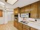 Bright kitchen featuring wooden cabinets, electric cooktop, and white countertops at 10951 Rosalie Dr, Northglenn, CO 80233