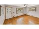 Bright living room featuring hardwood floors, fresh paint, ceiling fan and windows at 10951 Rosalie Dr, Northglenn, CO 80233
