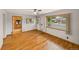 Living room featuring hardwood floors, a window with natural light, and view into kitchen at 10951 Rosalie Dr, Northglenn, CO 80233