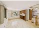 Bright living area with hardwood floors, built in shelves and a view into the kitchen at 10951 Rosalie Dr, Northglenn, CO 80233