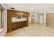 Spacious living room with hardwood floors, built in shelves and a door to another room at 10951 Rosalie Dr, Northglenn, CO 80233