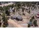 An aerial shot of a residential single-Gathering home situated in a wooded area, offering privacy and a serene setting at 11033 Barker Ave, Conifer, CO 80433