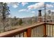 View from deck with a bird feeder and natural landscape of trees and mountains in the background at 11033 Barker Ave, Conifer, CO 80433