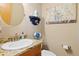 Cozy bathroom with granite counters, oval mirror, and artistic decor elements at 11033 Barker Ave, Conifer, CO 80433