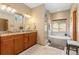 Ensuite bathroom is complete with double sink vanity, soaking tub and tiled stand-up shower at 11033 Barker Ave, Conifer, CO 80433