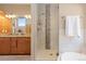 Ensuite bathroom features double sink vanity with granite counters and tiled stand-up shower at 11033 Barker Ave, Conifer, CO 80433