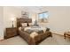 Comfortable bedroom featuring a decorative quilt, wood furniture, and natural light from the window at 11033 Barker Ave, Conifer, CO 80433