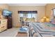Bedroom with large window offering outdoor views, desk, chair, ceiling fan, and side tables at 11033 Barker Ave, Conifer, CO 80433