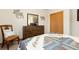 Cozy bedroom featuring a quilt, wood dresser, and nature-themed decor at 11033 Barker Ave, Conifer, CO 80433