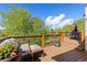 Relaxing deck area with lounge chairs, ottomans, and a variety of plants, perfect for outdoor enjoyment at 11033 Barker Ave, Conifer, CO 80433