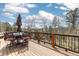 Outdoor deck with table, umbrella, chairs and a view of the mountain landscape with blue sky at 11033 Barker Ave, Conifer, CO 80433