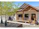 Attractive home featuring a welcoming front porch, complemented by a bear statue and tasteful landscaping at 11033 Barker Ave, Conifer, CO 80433