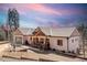Charming home featuring a covered porch, attached garage, and professionally landscaped yard at 11033 Barker Ave, Conifer, CO 80433