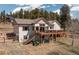 Spacious two-story house with a large deck and outdoor stairs at 11033 Barker Ave, Conifer, CO 80433