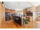 Bright kitchen features wood floors, an island with seating, granite counters, and stainless steel appliances at 11033 Barker Ave, Conifer, CO 80433