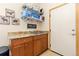 Convenient laundry room is complete with utility sink, storage and shelving at 11033 Barker Ave, Conifer, CO 80433