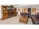 Cozy living room with a large TV, entertainment center, and comfortable leather seating at 11033 Barker Ave, Conifer, CO 80433