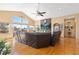 Spacious living room with vaulted ceilings, wood floors, stone accent wall, and scenic views at 11033 Barker Ave, Conifer, CO 80433