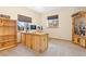 Functional office with a large wooden desk, custom cabinets, and bright natural light at 11033 Barker Ave, Conifer, CO 80433