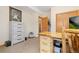 Functional office with a light wood desk, white dresser, and natural light at 11033 Barker Ave, Conifer, CO 80433