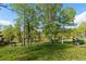 Landscaped yard with trees and a lawn mower at 11033 Barker Ave, Conifer, CO 80433