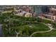 Aerial view showcasing the city park, walking trails, and condo buildings in the distance at 1700 Bassett St # 703, Denver, CO 80202